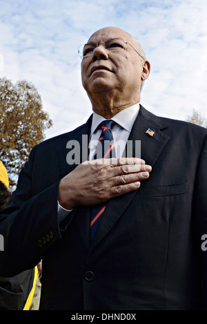 Former Secretary of State General Colin Powell stands for the pledge as he looks toward the Vietnam Veterans Memorial Wall during Veterans Day observances November 11, 2013 in Washington, DC. Thousands of people gathered at the wall for a Veterans Day event to remember those who died in the conflict and to honor all who served. Stock Photo