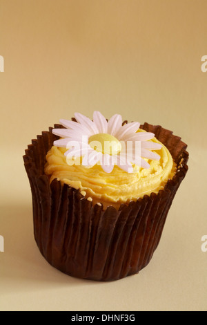lemon daisy cupcake isolated on pale yellow background Stock Photo