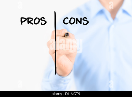 Young businessman holding a marker and writing pros and cons comparison concept for weigh all arguments Stock Photo