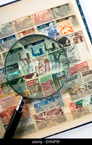 Postage stamp collection album with a magnifying glass on it Stock Photo