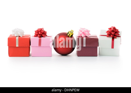 Multi color gift boxes and Christmas bauble in a row Stock Photo