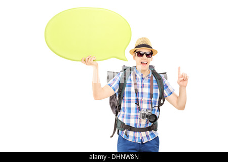 Young male tourist holding an empty speech bubble and gesturing with his finger Stock Photo