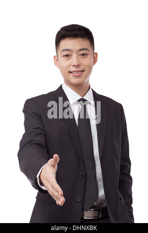 Business man extending a hand to shake Stock Photo