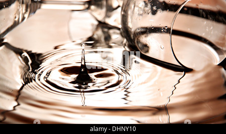 Closeup Pictures Orange Water drops and Beverage glass in Basin. Stock Photo