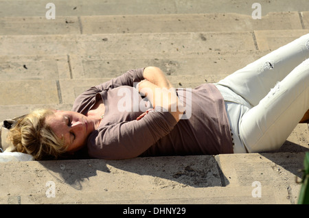 Young women sunbathe in the autumn sunshine Stock Photo