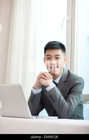 Businessman sitting by a laptop Stock Photo