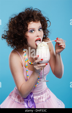 portrait of beautiful curly brunette girl with the glass of milk shake Stock Photo