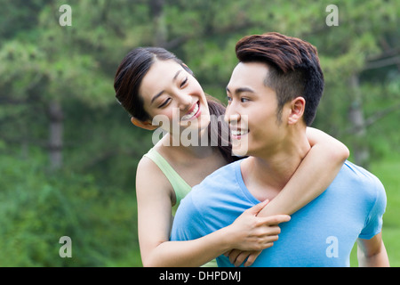 Young man giving her girlfriend a piggy back ride Stock Photo