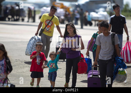 Cebu City, Philippines. 14th Nov, 2013. Evacuees arrive on C130 Military Transport Planes at Mactan International Airport Cebu City.Most are from the Typhoon's hardest hit areas of Tacloban,Leyte and Guiuan,Eastern Samar. All have their own individual stories of how they managed to survive the Typhoon's ferocity. Relief clearly showing on the faces of some. Credit:  imagegallery2/Alamy Live News Stock Photo