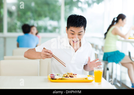 Good looking hungry man having his meal Stock Photo - Alamy