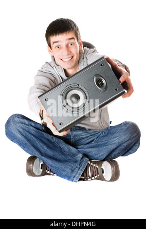 Smiling young man with a speaker in his hands Stock Photo