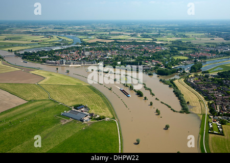 Netherlands, Doesburg. IJssel river. City center. Flooded land and floodplains. Cargo ship. Aerial Stock Photo