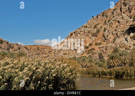Remote wilderness and scenic mountain views at Preveli beach and lagoon or  'Palm Beach' on the south coast of Crete, Greece. Stock Photo