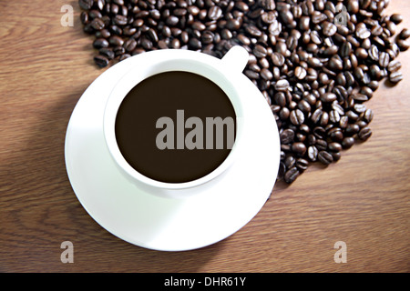 The Picture Focus Coffee cup and coffee beans on the table old wood. Stock Photo