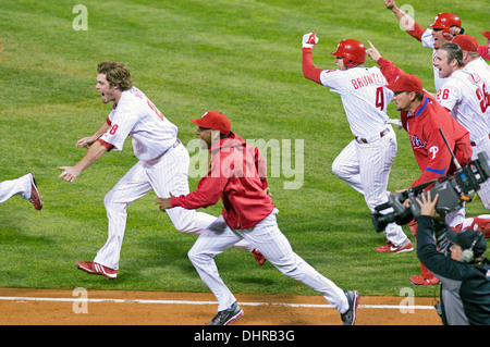 Philadelphia Phillies' Jayson Werth and teammates run up to celebrate after winning the game winning 2009 NLCS Game 4. Stock Photo