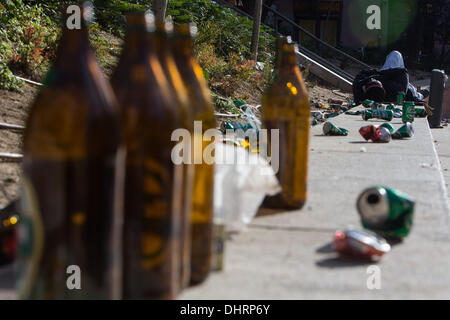 Madrid, Spain. 10th Nov, 2013. A man lying surrounded by beer bottles and cans in a square on November 10, 2013 in Madrid, Spain. Street cleaners, trash collectors an public park gardeners working for Madrid city council started an open-ended strike on November 5, 2013, called by trade unions against layoffs and salary cuts. Madrid's municipal cleaning companies plan to axe around 1,000 jobs and cut wages by 40 percent.Photo: Alvaro Hurtado/NurPhoto © Alvaro Hurtado/NurPhoto/ZUMAPRESS.com/Alamy Live News Stock Photo