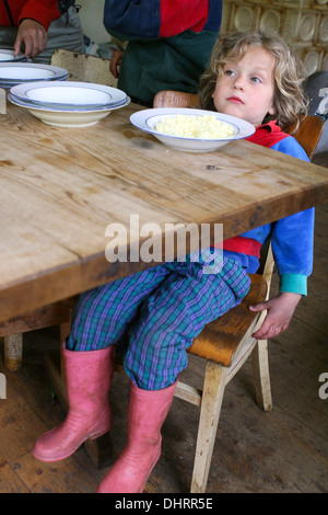 Child contemplating over the full plate toddler alone Stock Photo - Alamy