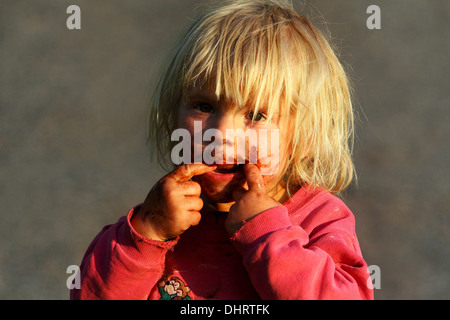 smeared face of a little blond boy with chocolate Stock Photo