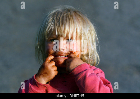 smeared face of a little blond boy with chocolate Stock Photo