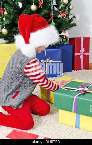 Little girl preparing Christmas gifts 