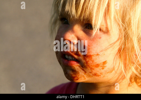 smeared face of a little blond boy, toddler child Stock Photo