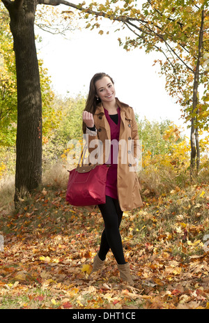 young woman walking in park Stock Photo