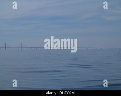 Oresundsbron. The Oresund bridge link between Denmark and Sweden, Europe, Baltic Sea. View from sailboat. Overcast stormy sky. Stock Photo