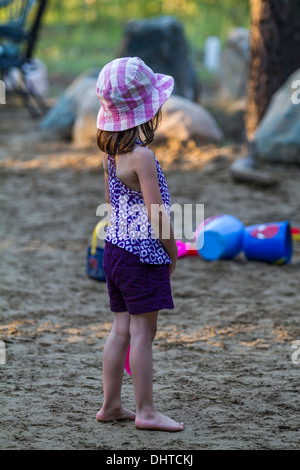 Model released young girl, outdoors, playing badminton in the sand. Stock Photo