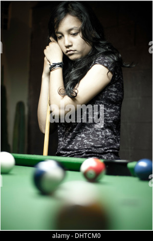 Young asian woman playing billiard. Stock Photo