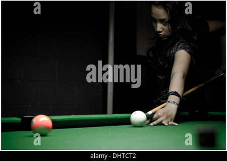 Young asian woman playing billiard. Stock Photo