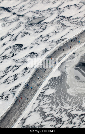 Netherlands, Loosdrecht, People ice skating on frozen lakes called Loosdrechtse Plassen. Aerial Stock Photo