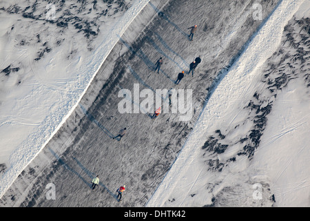 Netherlands, Loosdrecht, People ice skating on frozen lakes called Loosdrechtse Plassen. Aerial Stock Photo