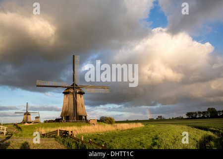 Netherlands, Schermerhorn, Windmills against dark sky Stock Photo
