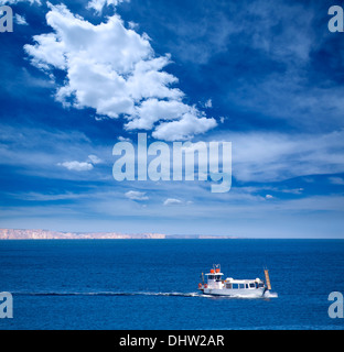 Menorca Son Saura beach in Ciutadella boat sailing at Balearic islands Stock Photo