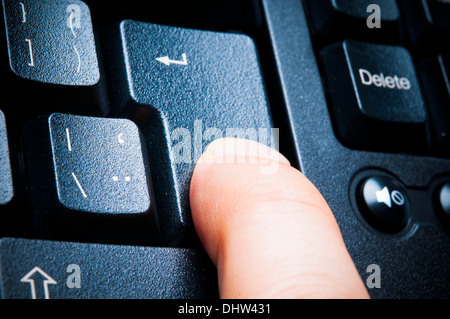 pressing a keyboard enter key Stock Photo