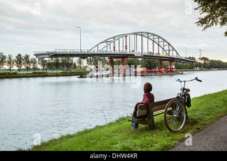 Netherlands, Weesp, Replacement of bridge on canal called Amsterdam-Rijnkanaal. Woman looking Stock Photo