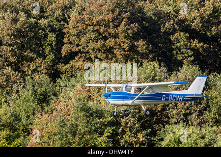 Netherlands, Loosdrecht, Little airplane, Cessna 172 in front of trees. Landing at airport Stock Photo