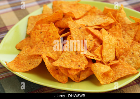 Heap of nachos on green plate. Stock Photo