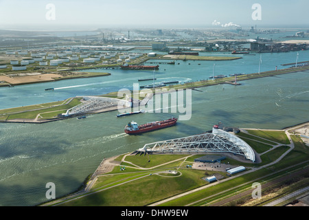 Holland, Rotterdam, Port. Maeslant barrier, Maeslantkering. Storm surge barrier Delta works. Oil storage chemical tanker. Aerial Stock Photo