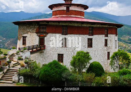 Paro,main street,traditional architecture,richly decorated buildings housing small shops surrounded by farms rice paddies,Bhutan Stock Photo