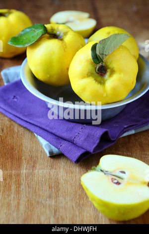 ripe yellow quince, rustic table, food Stock Photo