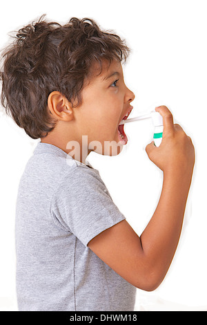 CHILD USING SPRAY IN MOUTH Stock Photo