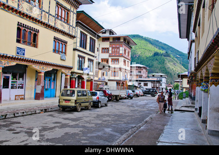 Paro,main street,traditional architecture,richly decorated buildings housing small shops surrounded by farms rice paddies,Bhutan Stock Photo