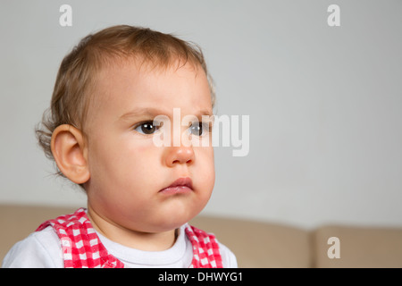 Portrait of a sad or angry looking baby Stock Photo