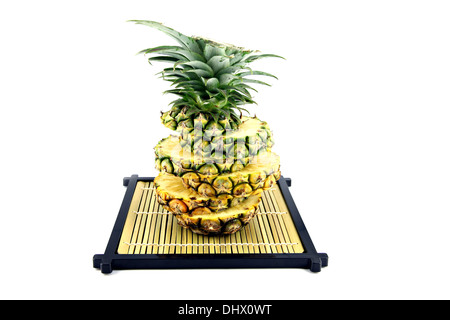 https://l450v.alamy.com/450v/dhx0wt/the-picture-pineapple-slices-stacked-on-a-bamboo-dish-dhx0wt.jpg
