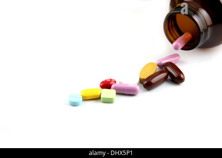 The Pill of many color Beside the bottle on white background. Stock Photo