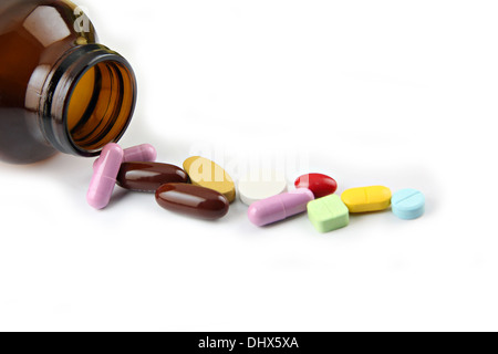 The Pill of many color Beside the bottle on white background. Stock Photo