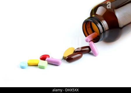 The Pill of many color Beside the bottle on white background. Stock Photo