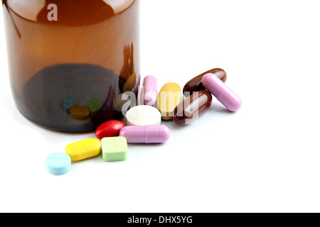 The Pill of many color Beside the bottle on white background. Stock Photo