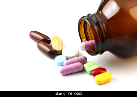 The Pill of many color Beside the bottle on white background. Stock Photo